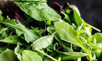 Leaves mix of spinach greens, arugula and basil close up. Ingredients for healthy eating.