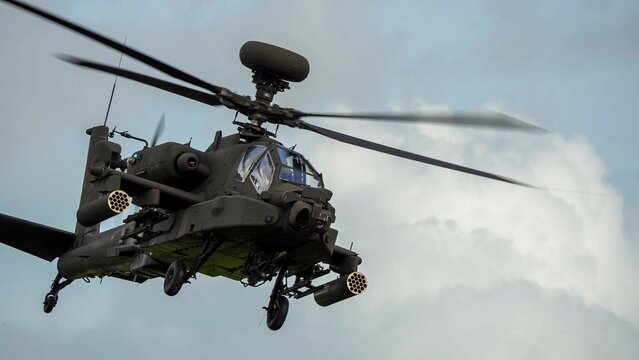 close-up front quarter view of ZM707 British army Boeing Apache Attack helicopter gunship (AH64E AH-64E ArmyAir606) in low level flight 