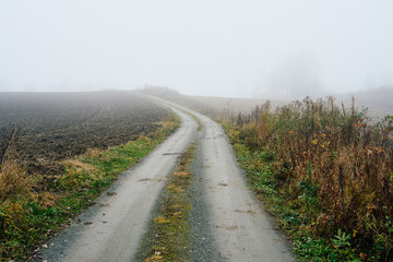 gravel road through the fog in the country