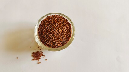 Halim Seeds in a glass bowl against a white paper background.