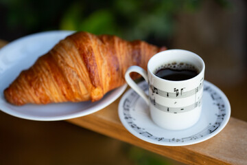 Coffee cup with croissant