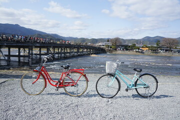 Red and Light blue city bicycle parked at the rocky shores