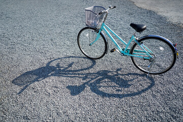 Naklejka na ściany i meble Light blue colour city bicycle park at the rocky floor with nice bicycle shadow on the left