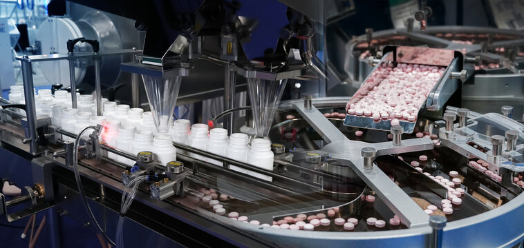Closeup of pharmaceutical medicine tablet pill production, Pharmaceutical industry, transfer medicine bottles on the conveyor belt in the pharmaceutical industry, medical factory production line. 