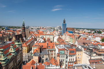 Fototapeta na wymiar Wroclaw's old town, roofs of tenement houses and the Market Square on a sunny summer day. City.