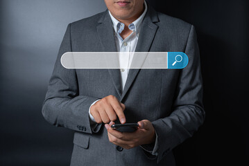 Close up businessman pushing, touching on smartphone with virtual search bar on black and gray background