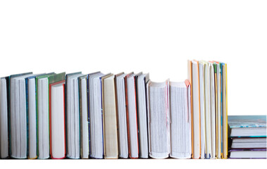 many books in a row stand on the table on Isolated white background.