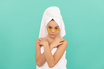 teen girl in shower towel with golden patch. perfect skin