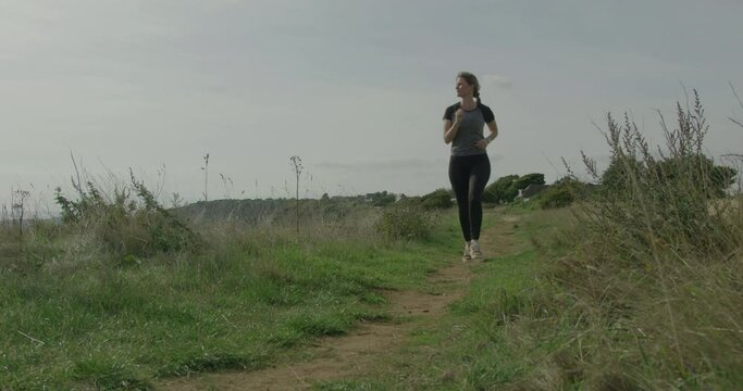 One Mid Adult Female Running in Nature