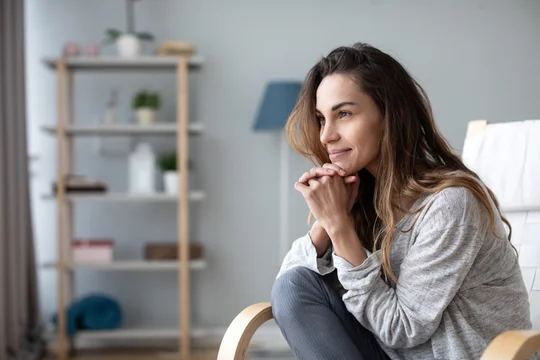 Joyful happy woman close-up sitting in a chair