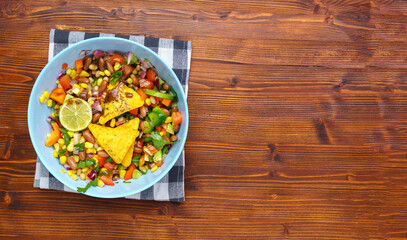 Cowboy caviar, texas caviar corn, beans, tomatoes, avocado, lime Served with nachos chips corn. Copy space