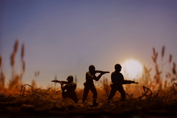 Fototapeta na wymiar Military scene with Toy Soldiers on a Battlefield, concept of war and armed conflict