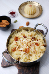 Rava Sheera or Suji ka halwa, shira is an indian sweet dish, made with semolina, sugar, ghee and dry fruits. served as dessert or as Prasad during festivals. Garnished with saffron. Copy space.