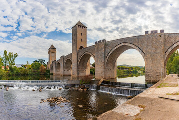 Fototapeta na wymiar The Pont Valentre is a 14th-century six-span fortified stone arch bridge crossing the river Lot to the west of Cahors, in France. It has become a symbol of the city.