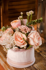 A delicate flower composition of pink roses and carnations