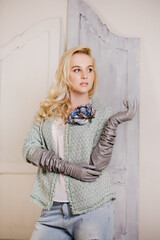 A woman in a tweed jacket with long grey leather gloves