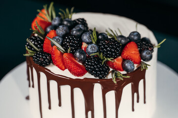 juicy berries on white chocolate cake