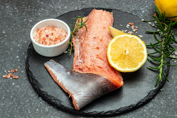 Fresh raw salmon red fish, Raw fish trout steak with spices and herbs on dark slate table. place for text, top view