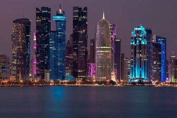 Fototapeta na wymiar Doha, Qatar- December 23,2019 : Night view of Skyline, Doha's Financial District (West Bay).
