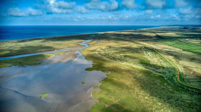 Fototapeta Aerial view of Norfolk marshland nature reserves near Blakeney, with the North Sea in the background