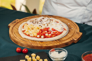 pizza cooking process, cherry tomatoes, mushrooms and cheese