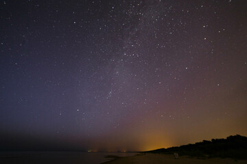 Fototapeta na wymiar Deep night sky with many stars and forest and sea