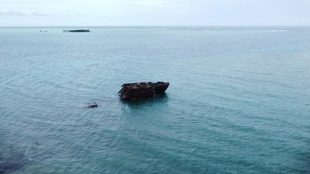 Drone view of Rocky cay aground ship on calm turquoise sea waves in San Andres Island, Colombia