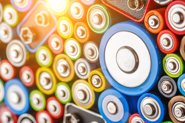 Energy abstract background of colorful batteries.Old used batteries ready for recycling.Used batteries from different manufacturers, waste, collection and recycling,Alkaline battery aa size.