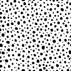 Unusual polka dot texture. Black and white dotted background. Hand drawn dots seamless pattern. Original sketchy graphic of rounded spots. Overlap design elements. Vector illustration.