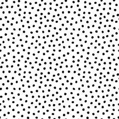 Hand drawn different sized chaotic speckles, flecks, stains or dots seamless pattern. Unusual polka dot black on white abstract monochrome background. Uneven specks, spots, blobs, splashes texture.