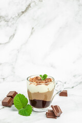 dessert three chocolates with mint on a light background. Layered delicious dessert. vertical image. place for text