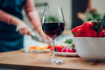 Red wine in a glass standing on a kitchen counter