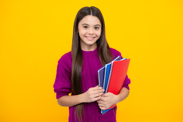 Teen girl pupil hold books, notebooks, isolated on yellow background, copy space. Back to school, teenage lifestyle, education and knowledge.