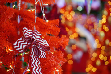 Ribbon display at red Christmas tree.