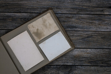 Clear blank photo frames to placed your pictures or text on old family album on wooden background...