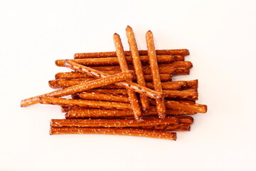 Salted Baked brown Pretzel Sticks on white background,top view,copy space