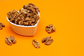 bowl full of almonds on a colored background