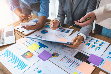 Financial analyst analyzes business finance reports on laptop and graph documents during corporate...