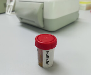 Stool sample in Plastic container for Fecal Fat test, to diagnose conditions causing malabsorption.