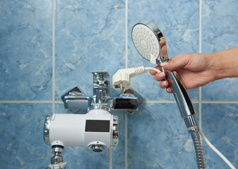 Shower with electric water heater in the bathroom