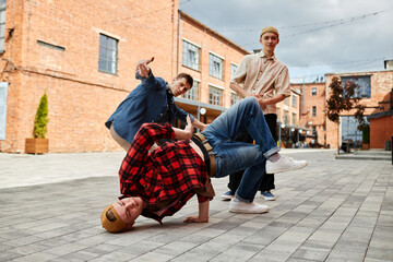 Full length shot of all male breakdance team posing outdoors in city setting © Seventyfour