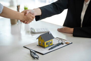Successful deal Real estate lease or home purchase concept buyer shakes hands with bank employee...
