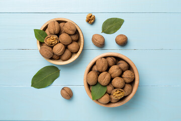 Fresh walnuts on wooden background, top view