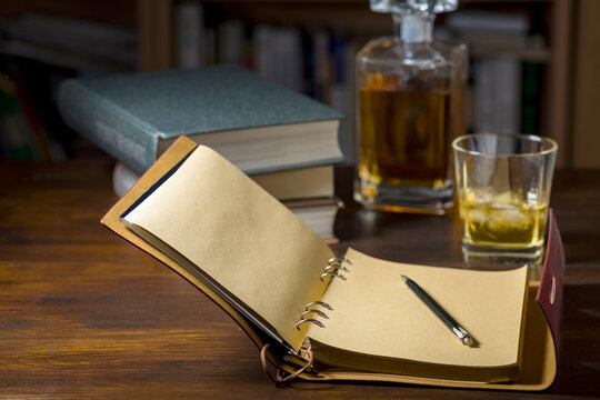 Ready to write, a glass of whiskey and some books