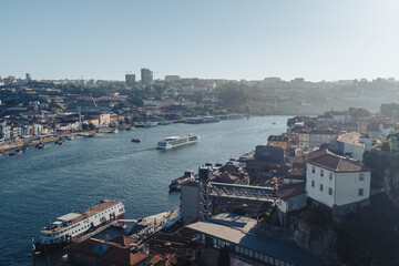 Douro river view scene crossing Oporto city on a blue summer day with some tourist boats cityscape