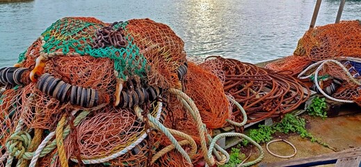 Fishing nets and ropes with sea beyond