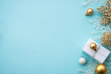 Christmas composition with holiday decorations on blue.