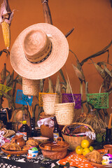 Traditional Mexican Day of the Dead altar with offerings of bread and fruit in Mexico for the Día...
