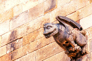 Fototapeta na wymiar Medieval stone gargoyle in the Gothic district in Barcelona, Spain