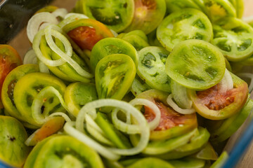 Freshly sliced green tomato, ready to make a salad. Photo taken in natural, soft light.